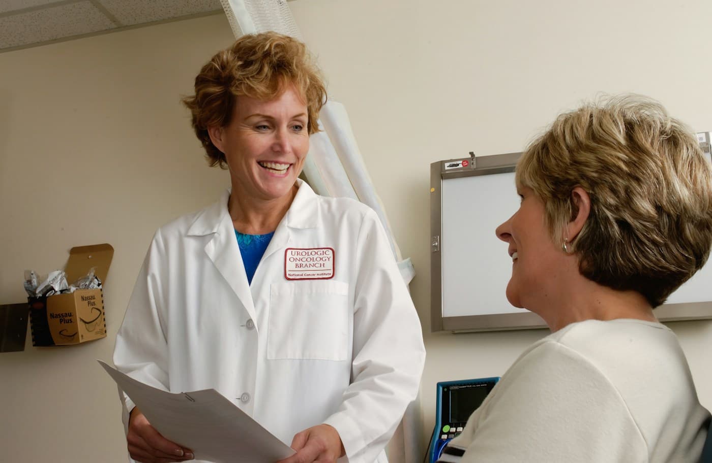 A doctor and patient smiling together during a consultation